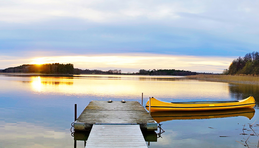 canadian canoe in lake at sunset