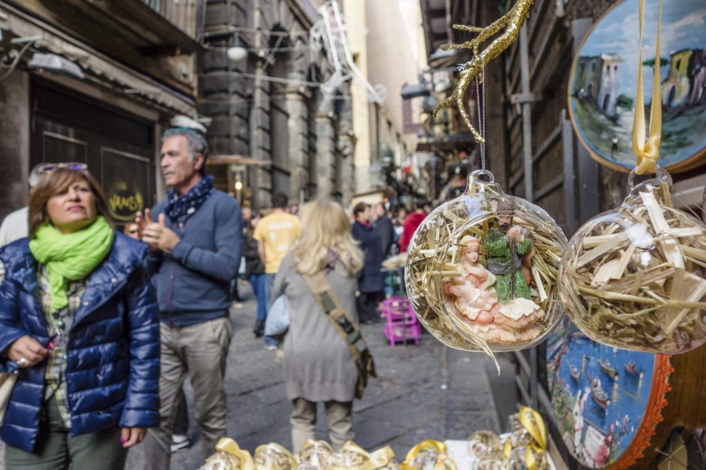 Naples, Italy - November 9, 2014: Christmas Market in Naples, Italy. Some people walking in the street observing the Christmas decorations for sale.